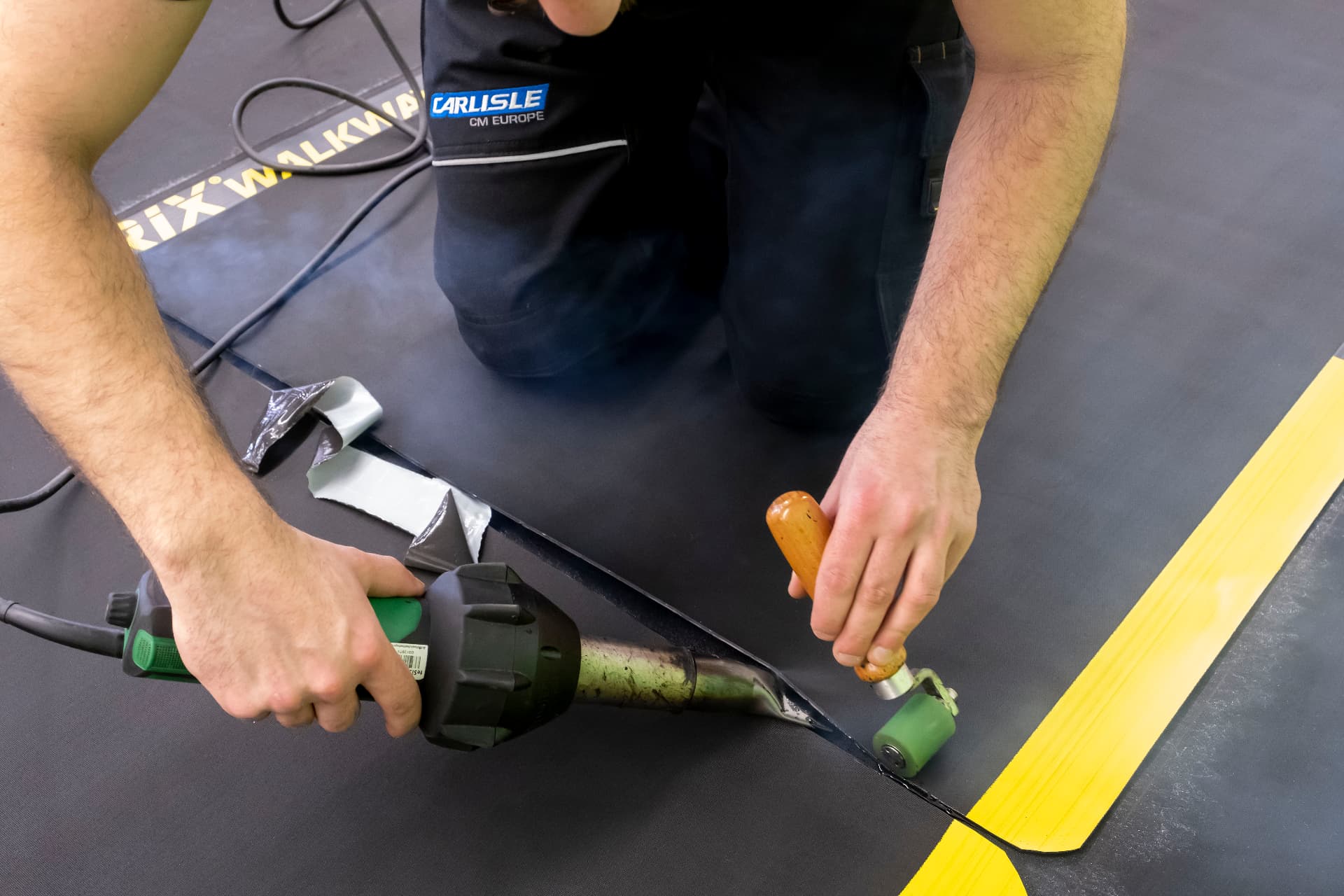 Close-up of a RESITRIX seam being hot-air welded and rolled
